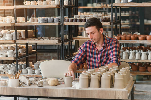 istock Caucasian male potter making ceramic cap in the pottery. 1339882221