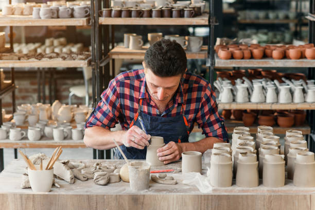 istock Caucasian male potter making ceramic cap in the pottery. 1339882312