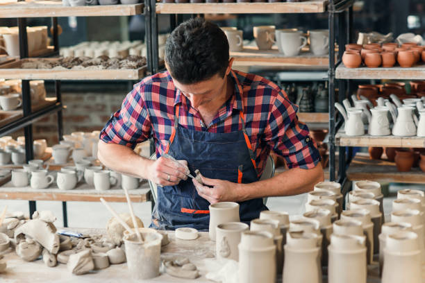 istock Talanted caucasian man making decoration for cup. 1339884278