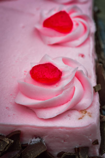istock pink cake frosting swirled piped dollops 1339887187