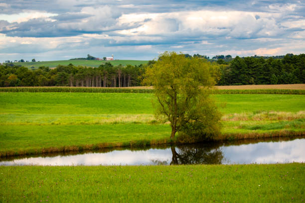 Wisconsin farmland and  pond with a dramatic sky in September, horizontal