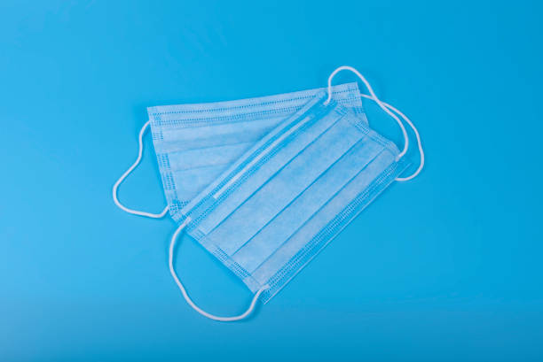 istock Medical mask on blue background good idea in coronavirus time. 1339888870