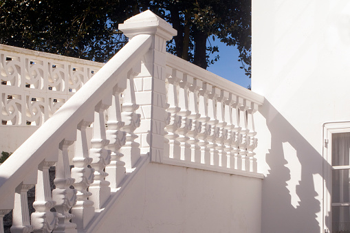 Detail of a white baluster and staircase, front yard side view. Costa da Morte, A Coruña province, Galicia, Spain.