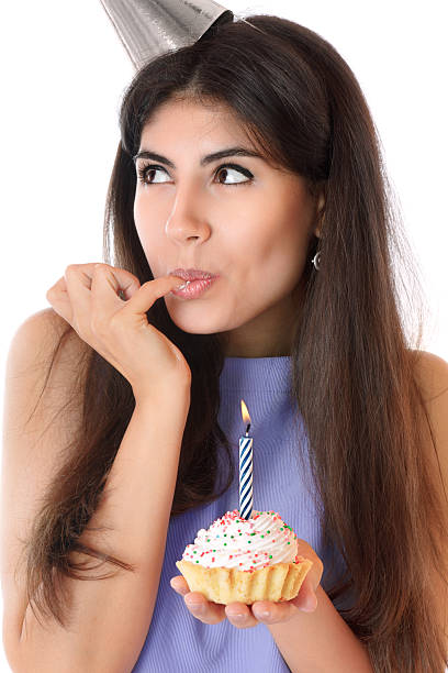istock Beautiful young woman eating cupcake 133988979