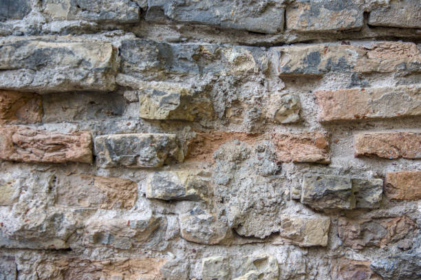 istock Grey red orange old vintage brick house wall background 1339894074