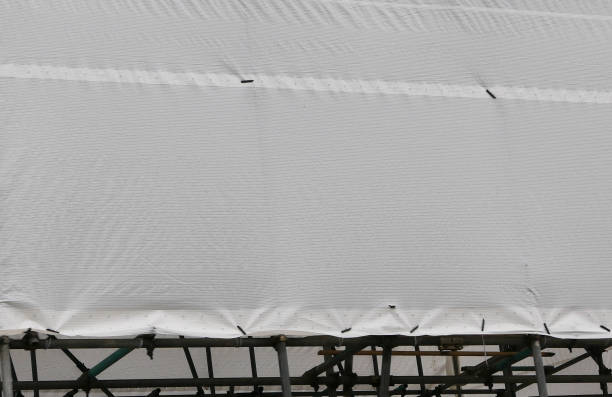 istock White tarpaulin concealing building 1339894124