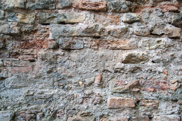 istock Grey red orange old vintage brick house wall background 1339894191
