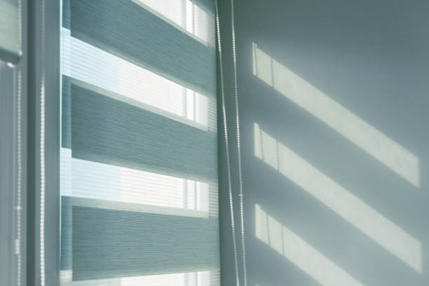 istock Close up of colored fabric roller blinds on window. Roll curtains. 1339894223