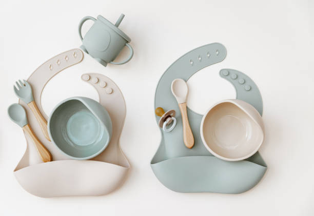 istock Baby Table Setting Background. Silicone set on light background. Place for text, copy space. Top view, flat lay. 1339894377