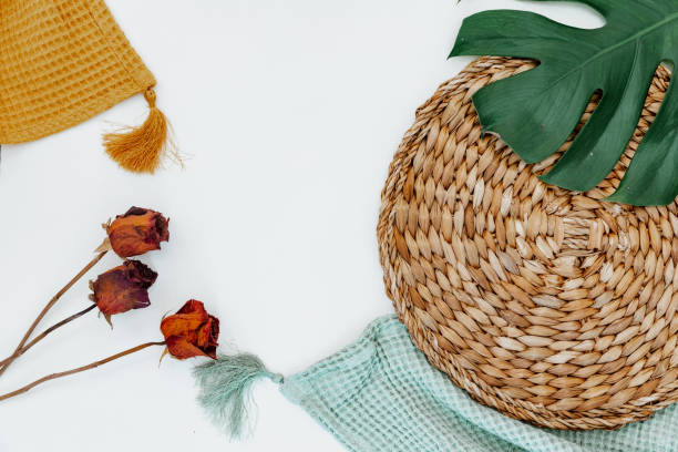 istock Flat lay monstera leaf, blanket and straw stand on white background. top view. 1339895044