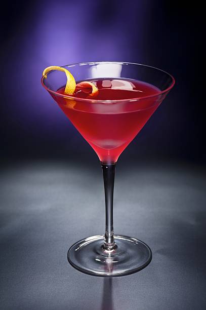 istock Cosmopolitan cocktail with lemon garnish in front 133989875
