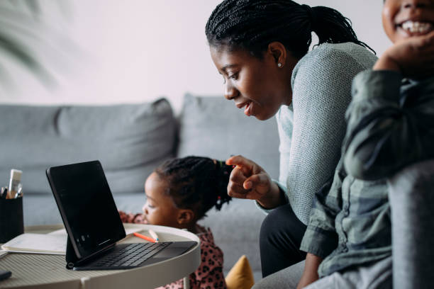 istock Super Mom: A Young Single Mother and Her Boy and a Girl Spending Creative Time Together at Home Using a Tablet 1339901299