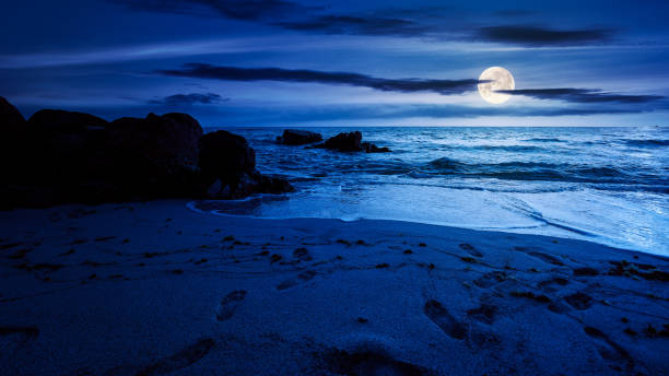 istock huge stones on the sandy beach at night 1339901390
