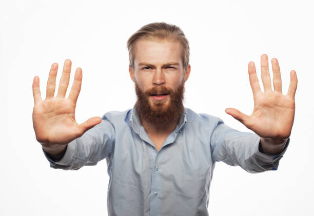 istock Young man wearing casual blue shirt afraid and terrified with fear expression stop gesture with hands, shouting in shock 1339929114