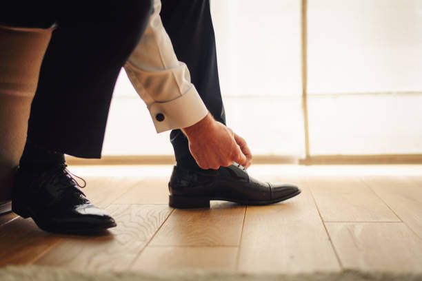 istock Groom dressing up with classic elegant shoe 1339931797