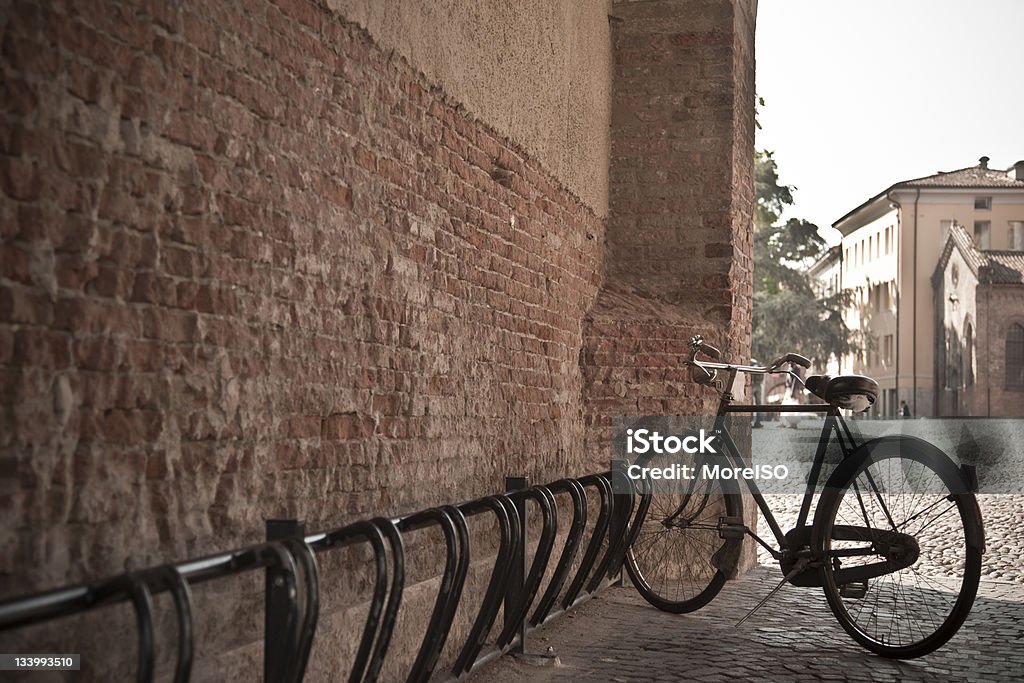Ferrara cityscape, Italy Ferrara cityscape, with old european-style bicycle in the shade. Ferrara is really famous for the high number of bicycles that is possible to see there. Brick Stock Photo