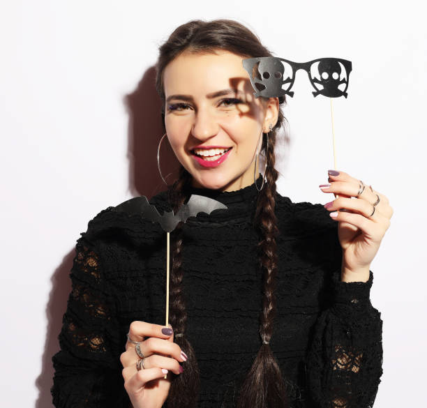 istock halloween party: playful young woman ready for party 1339937946