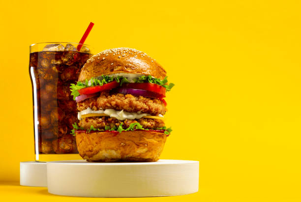 istock Delicious hamburger with cola on a yellow background 1339939801
