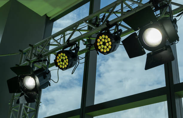 istock Studio lights attached to a steel structure attached to a glass flap on the building behind are the sunlight and clouds used for video productions 1339939959