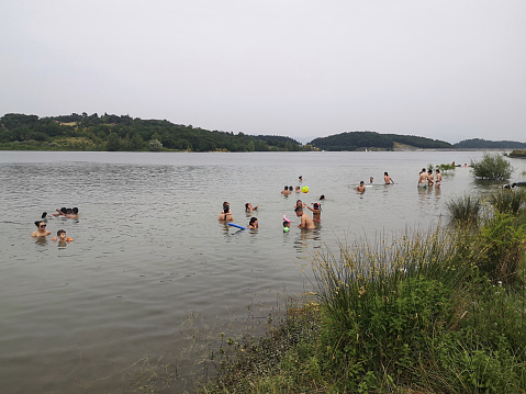 People bathing in Lago di Bilancino, an artificial lake near Barberino di Mugello in Florence province, Tuscany, Italy, made with a dam on the river Sieve.