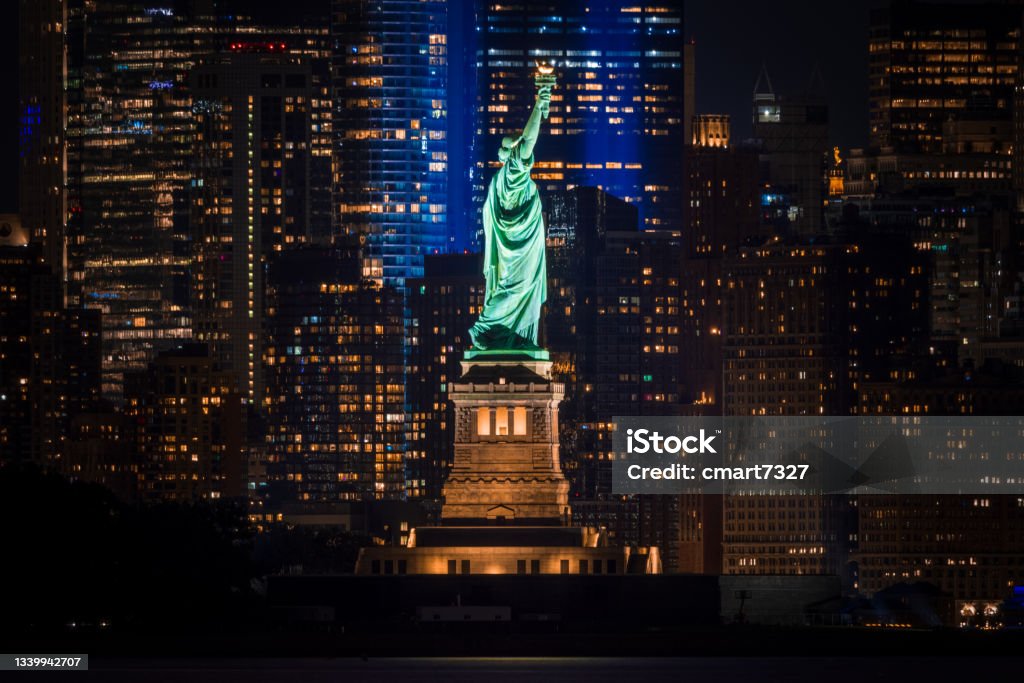 Statue of Liberty Salutes 9/11 Memorial The Statue of Liberty lined up with the Tribute in Light New York City Stock Photo