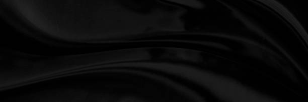 istock Black gray satin dark fabric texture luxurious shiny that is abstract silk cloth background with patterns soft waves blur beautiful. 1339944633