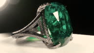 istock Macro filming of large green emerald stone in jewelry ring. Royal crystals. 1339948019
