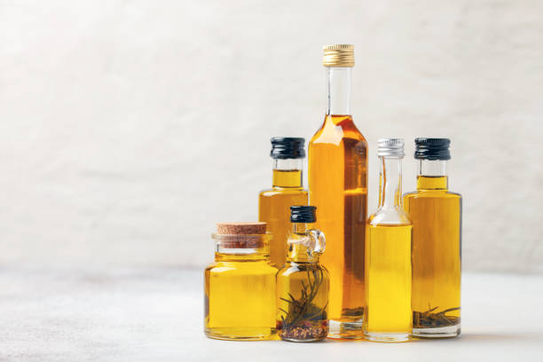 istock Various vegetable and nut oil in bottles on a bright background. 1339952209