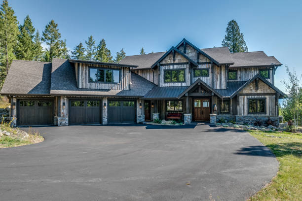istock Large mountain home with asphalt driveway 1339956220