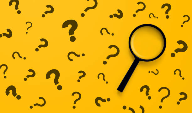 istock Magnifying glass and question mark sign on yellow background. Searching information data on internet networking concept 1339956385
