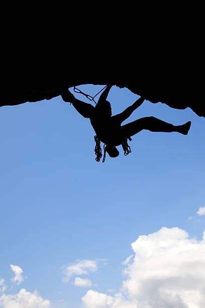 climber silhouette on blue sky background