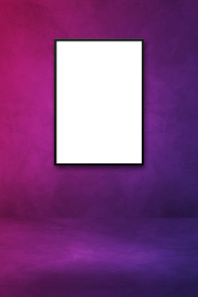 istock Black picture frame hanging on a purple wall 1339961009