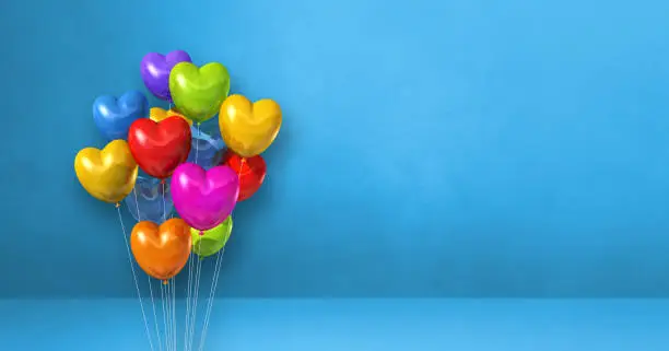 Colorful heart shape balloons bunch on a blue wall background. Horizontal banner. 3D illustration render