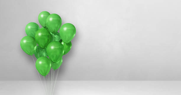 istock Green balloons bunch on a white wall background. Horizontal banner. 1339961163
