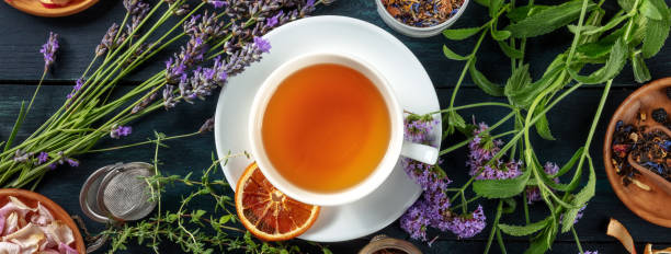 istock Tea panorama with herbs, flowers and fruit, shot from the top 1339963576