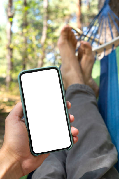 istock Cellphone with the empty white screen for your mockup in a man's hand 1339966130
