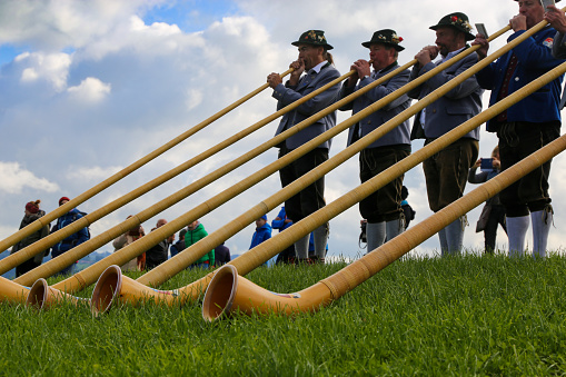 Alphorn players in Bavaria. The alphorn is a traditional wind instrument in the Alps (Waltenhofen, Germany, October 03, 2019)