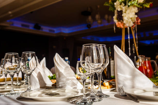 istock beautiful table setting. glasses, plates on round table in sunlight 1339969950
