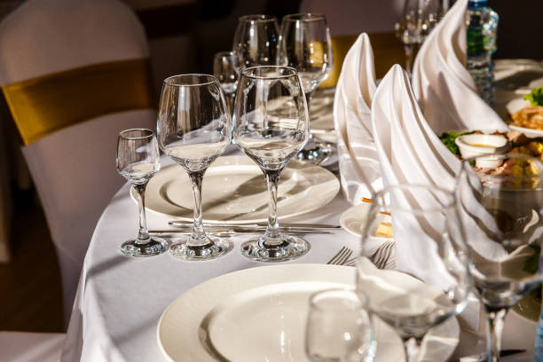 istock beautiful table setting. glasses, plates on round table in sunlight 1339969968