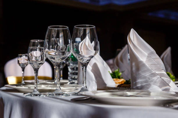 istock beautiful table setting. glasses, plates on round table in sunlight 1339969990