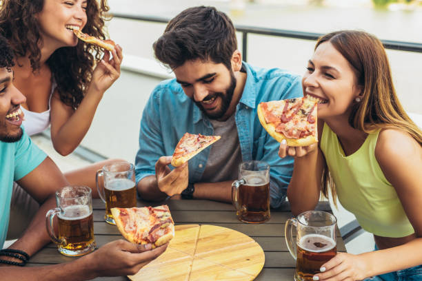istock Friends enjoying pizza. 1339971234