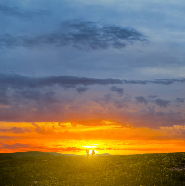 istock hikers stay among prairie at the dramatic sunset 1339973583