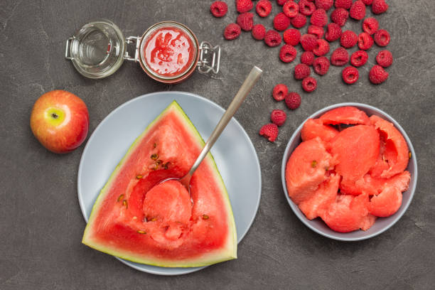 istock Spoon in pulp of ripe watermelon. 1339973683