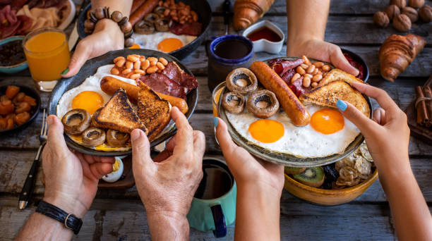 Close up view of breakfast table with family. Top view of a breakfast table. english breakfast stock pictures, royalty-free photos & images