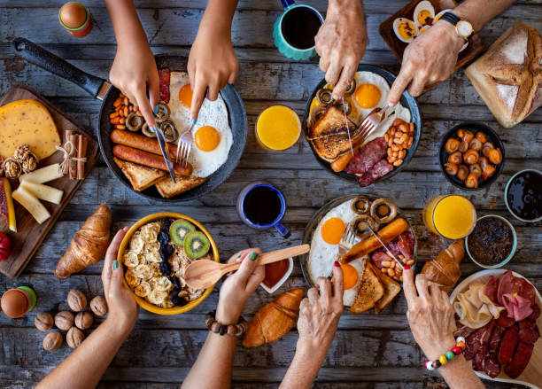 istock Close up view of breakfast table with family. 1339975689