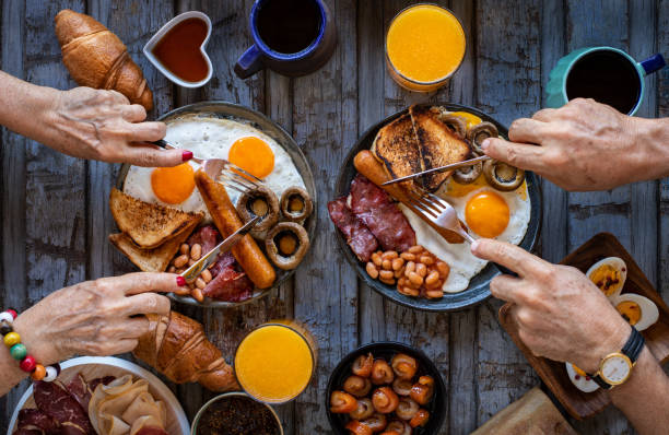 istock Close up view of breakfast table with family. 1339975711