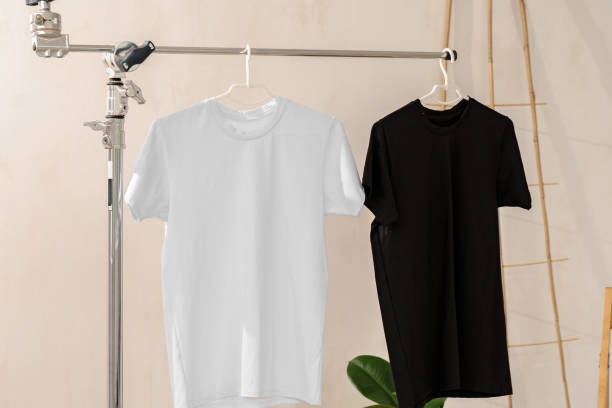 istock White and black T-shirts on hangers for design presentation 1339977160