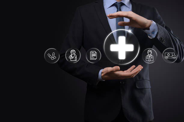 istock Businessman hold virtual plus medical network connection icons. Covid-19 pandemic develop people awareness and spread attention on their healthcare.Doctor,document,medicine,ambulance,patient icon. 1339981159