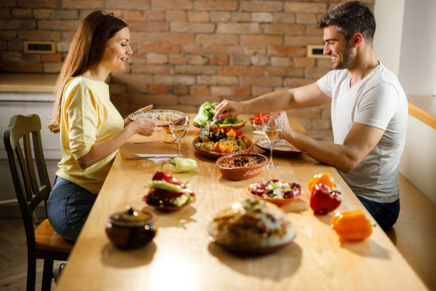 istock Happy couple enjoying in lunch at dining table. 1339981160