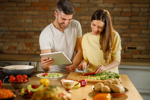 istock Happy couple enjoying making lunch in the kitchen. 1339981272